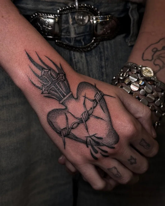 Medium Black and Grey Sacred Heart with Barbed Wire Tattoo on Women Hand by @juanca.ttt