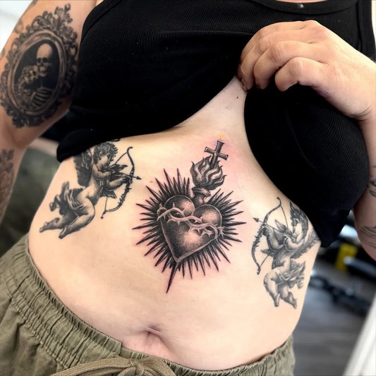 Medium Black and Grey Sacred Heart with Cherubs Tattoo on Women Torso by @meganrebekahtattoos