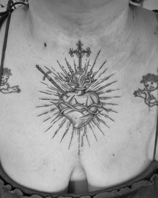 Medium Black and Grey Sacred Heart with Cherubs and Sword Tattoo on Women Chest by @quinstattoos