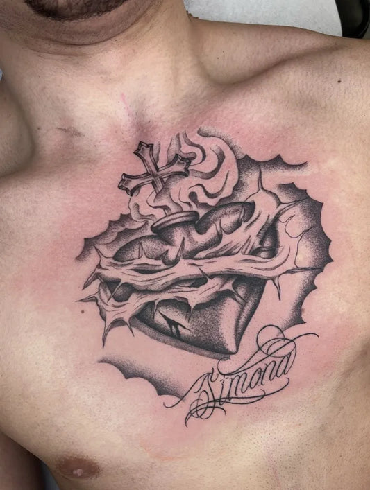 Medium Black and Grey Sacred Heart with Cross and Banner Tattoo on Men Chest by @amonet_ink_tattooer