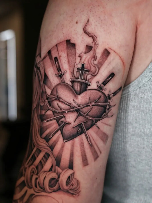 Medium Black and Grey Sacred Heart with Daggers and Flames Tattoo on Men Arm by @stevefranciosa.tattoos