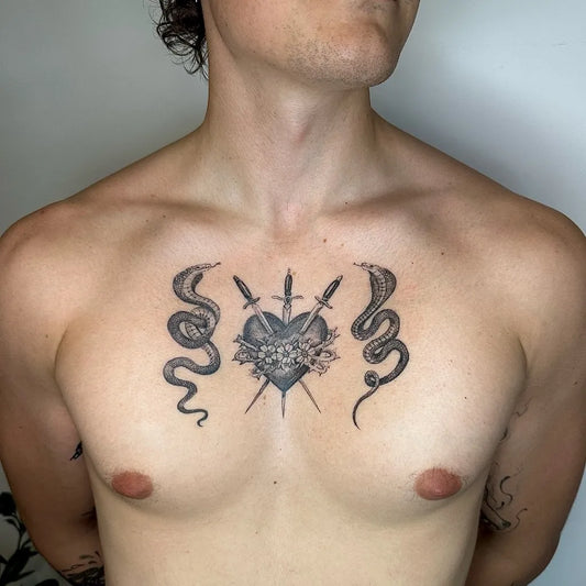 Medium Black and Grey Sacred Heart with Daggers and Snakes Tattoo on Men Sternum by @capu_tattoo