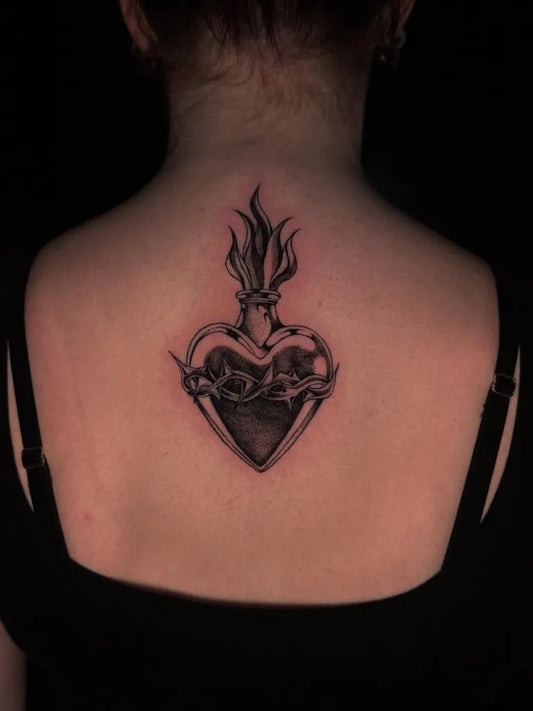 Medium Black and Grey Sacred Heart with Flames Tattoo on Women Back by @skin.shadyy