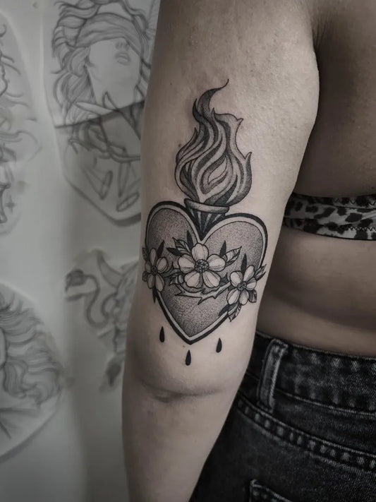 Medium Black and Grey Sacred Heart with Flames and Flowers Tattoo on Women Arm by @martius_tattooart