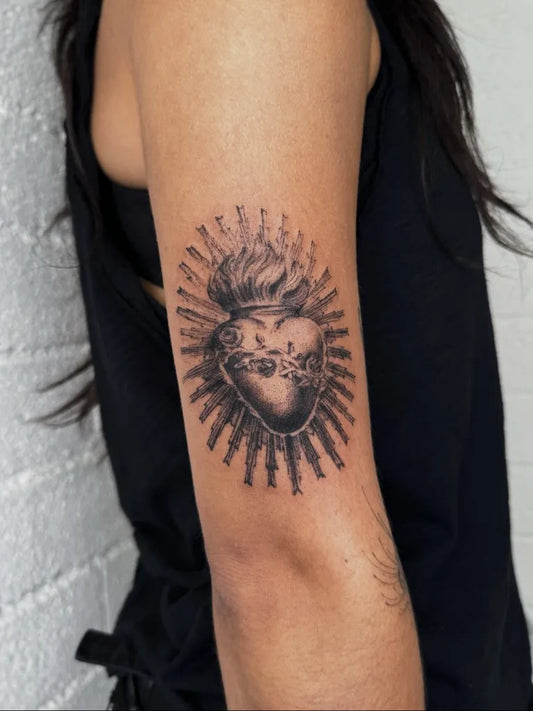 Medium Black and Grey Sacred Heart with Rays Tattoo on Women Arm by @nicolejaclynsmith