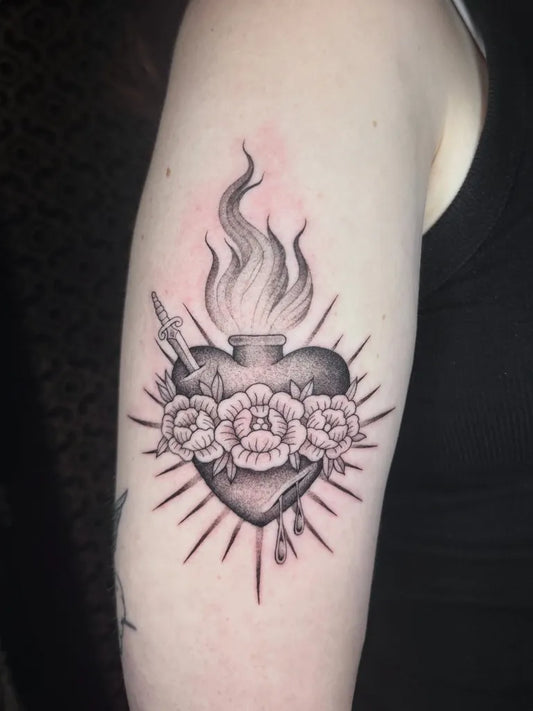 Medium Black and Grey Sacred Heart with Roses and Flames Tattoo on Women Arm by @moll.tattoos