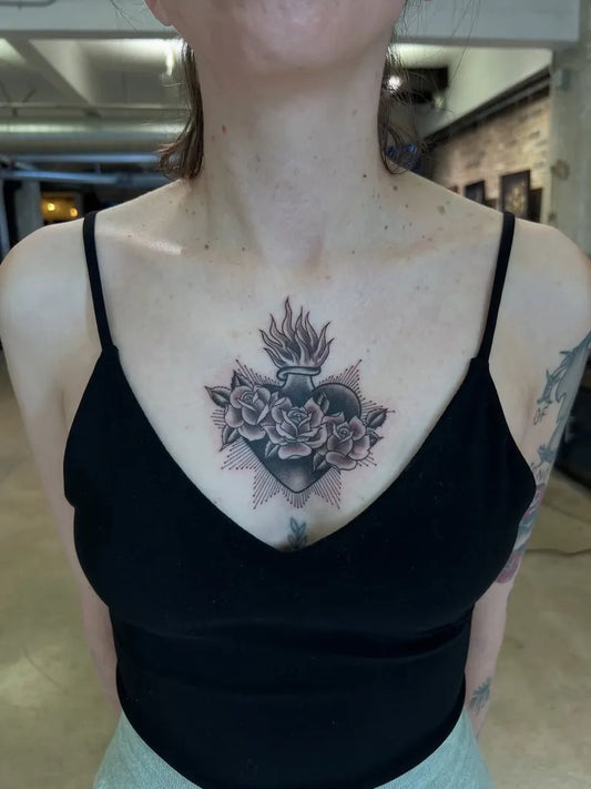 Medium Black and Grey Sacred Heart with Roses and Flames Tattoo on Women Chest by @vulgarartist