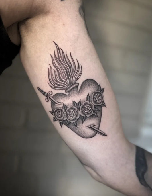Medium Black and Grey Sacred Heart with Sword and Roses Tattoo on Women Arm by @dianaregalado
