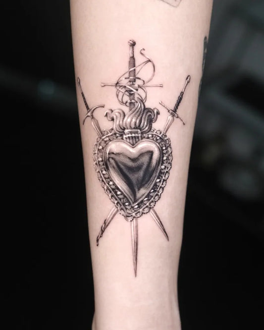 Medium Black and Grey Sacred Heart with Swords Tattoo on Women Arm by @hammersmith_tattoo_london
