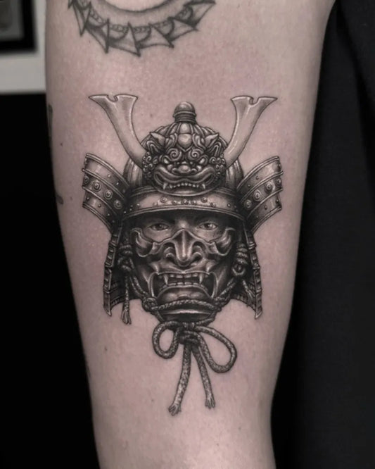 Medium Black and Grey Samurai Mask Tattoo on Men Arm by @freddo_tattooer