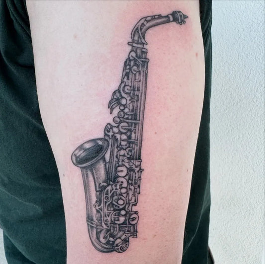 Medium Black and Grey Saxophone Music Tattoo on Men Arm by @tatdew