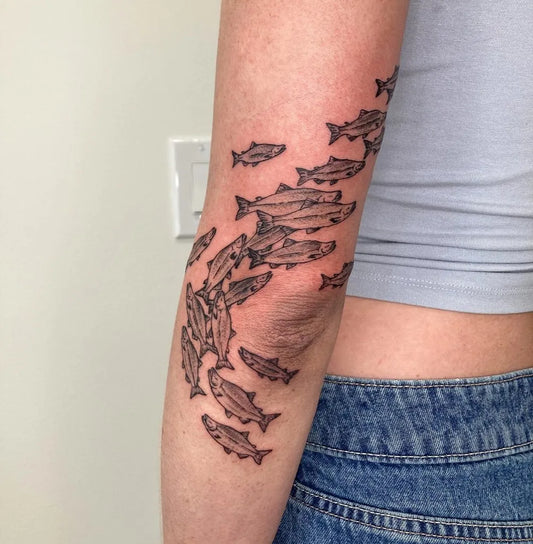 Medium Black and Grey School of Fish Tattoo on Women Arm by @lemon.inkade