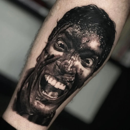 Medium Black and Grey Screaming Face Horror Tattoo on Men Arm by @dorstockertattoos