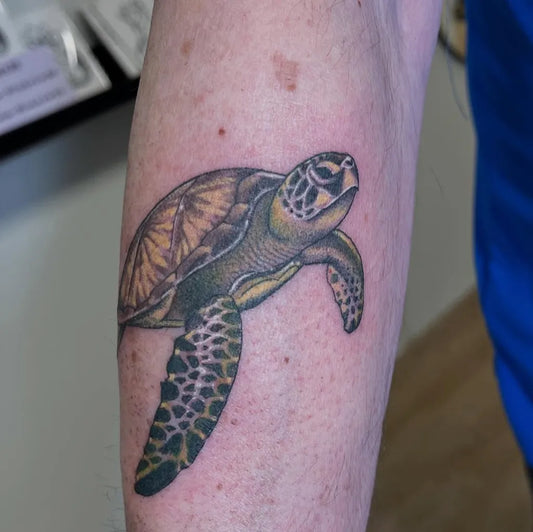 Medium Black and Grey Sea Turtle Tattoo on Men Arm by @rolling.sea