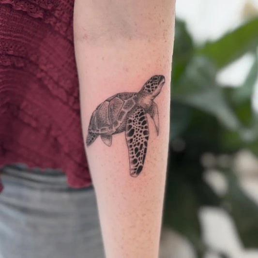 Medium Black and Grey Sea Turtle Tattoo on Women Arm by @the.peoples.ink