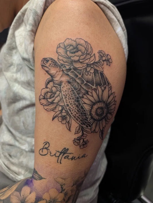 Medium Black and Grey Sea Turtle and Flowers Tattoo on Women Arm by @brandnewtattoo