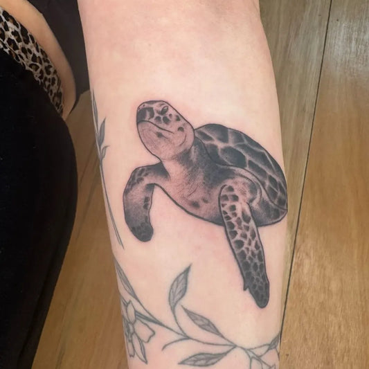 Medium Black and Grey Sea Turtle and Flowers Tattoo on Women Arm by @lrstattoo