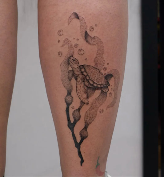 Medium Black and Grey Sea Turtle and Kelp Tattoo on Women Leg by @yahelkfirtattoos