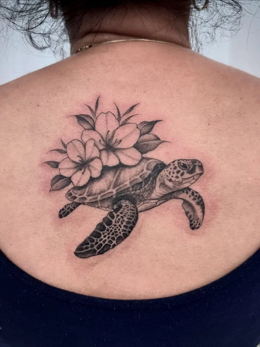 Medium Black and Grey Sea Turtle with Flowers Tattoo on Women Back by @shannonricetattoo