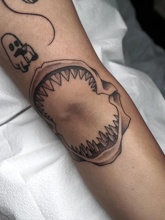 Medium Black and Grey Shark Jaw with Ghost on Women Arm Tattoo by @carlosthebarloswarlos_