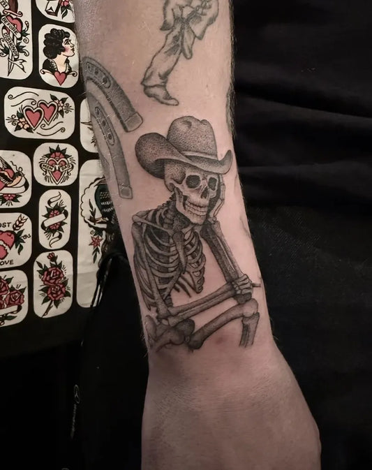 Medium Black and Grey Skeleton Cowboy Tattoo on Men Arm by @caseyjones.tattoo