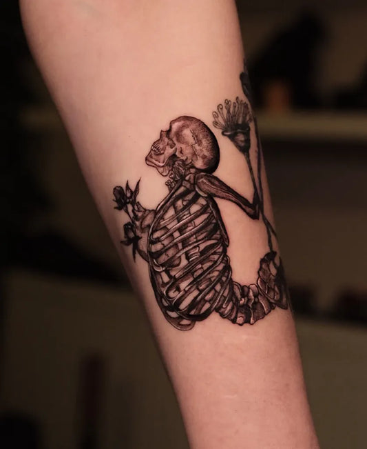 Medium Black and Grey Skeleton with Flowers and Staff Tattoo on Women Arm by @erayturaci