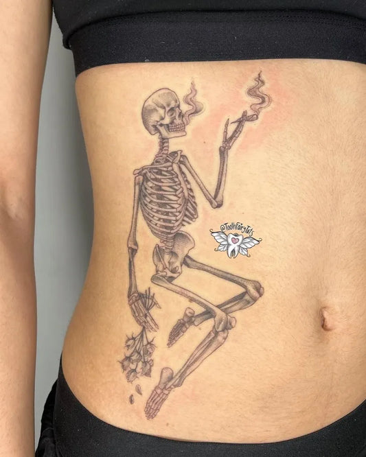 Medium Black and Grey Skeleton with Lotus Tattoo on Women Stomach by @toothfairy