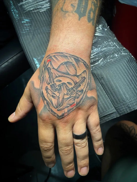 Medium Black and Grey Skull Shield Wings Military Tattoo on Men Hand by @studioseventattoos