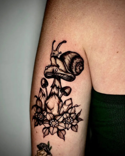 Medium Black and Grey Snail Mushroom Flowers Tattoo on Women Arm by @soriatattoos