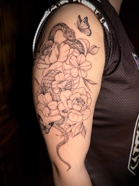 Medium Black and Grey Snake and Roses Tattoo on Women Upper Arm by @inkedbykate_