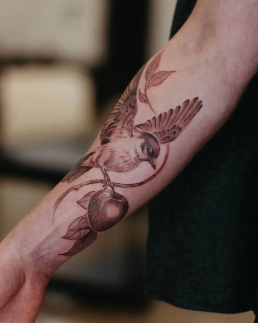 Medium Black and Grey Sparrow with Apple Tattoo on Men Arm by @yukitanukii