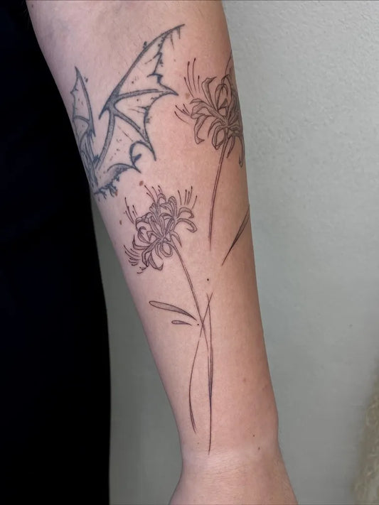 Medium Black and Grey Spider Lily Bat and Red Spider Lily Tattoo on Women Arm by @sd.tattoo.plzen