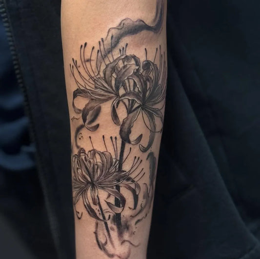 Medium Black and Grey Spider Lily black Tattoo on Women Arm by @sloth_inks