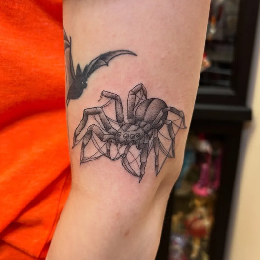 Medium Black and Grey Spider and Bat on Women Arm Tattoo by @doomsayer.art