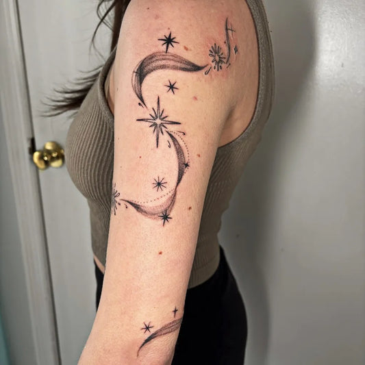 Medium Black and Grey Star and Swirl Tattoo on Women Upper Arm by @chloeshaytattoo