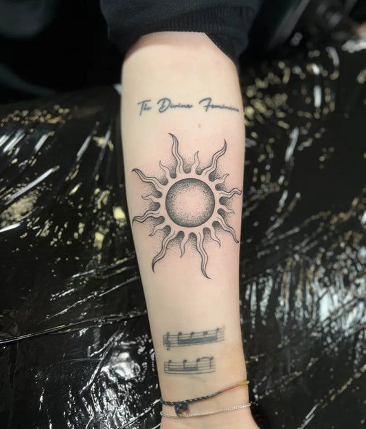 Medium Black and Grey Sun Script Musical Staff on Women Forearm Tattoo by @inksmithtattooclonmel_official