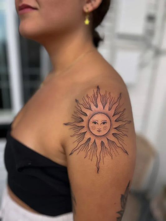 Medium Black and Grey Sun on Women Shoulder Tattoo by @seed.eternal
