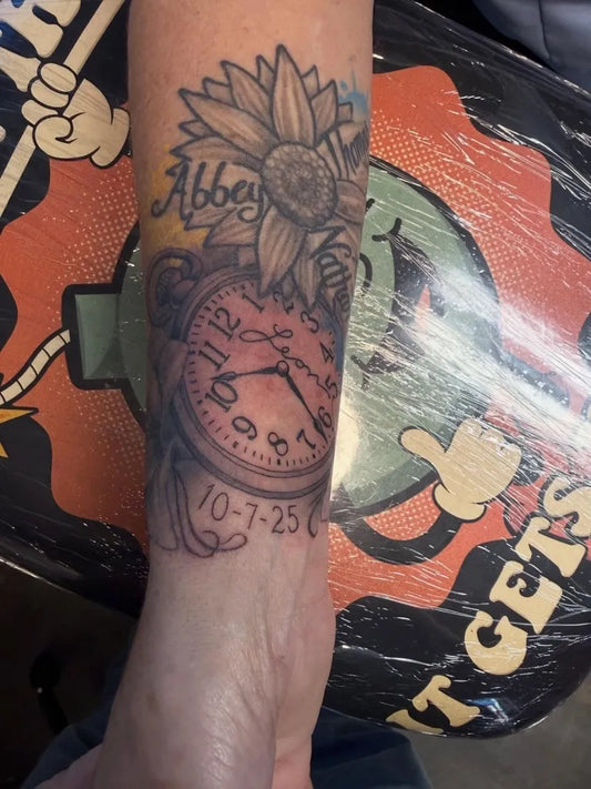Medium Black and Grey Sunflower Clock Tattoo on Women Arm by @subjectivearttattoo