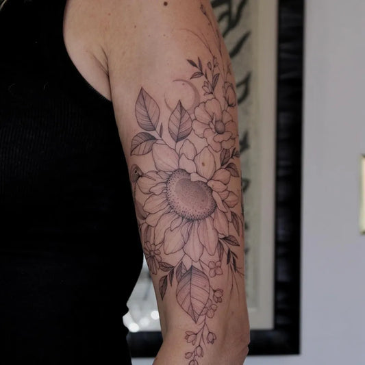 Medium Black and Grey Sunflower Flowers Leaves on Women Arm Tattoo by @theartofeverett