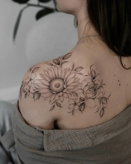 Medium Black and Grey Sunflower Rose Leaves on Women Shoulder Tattoo by @asya.tattoo