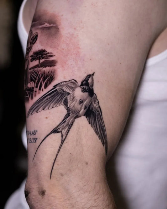 Medium Black and Grey Swallow and African Savanna Tattoo on Men Upper Arm by @53ronintattoo