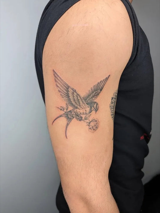 Medium Black and Grey Swallow with Flower Tattoo on Men Shoulder by @inkvisiontoronto