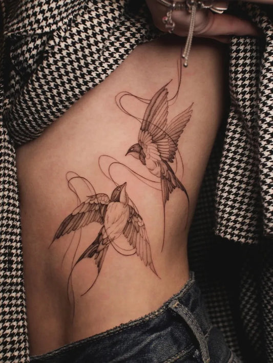 Medium Black and Grey Swallows Tattoo on Women Rib by @gabriela.staneva