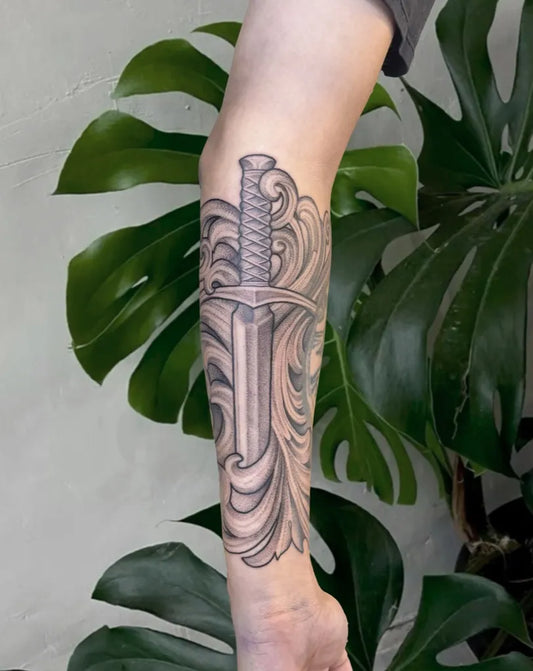 Medium Black and Grey Sword with Filigree on Men Arm Tattoo by @bethanysophtattoos