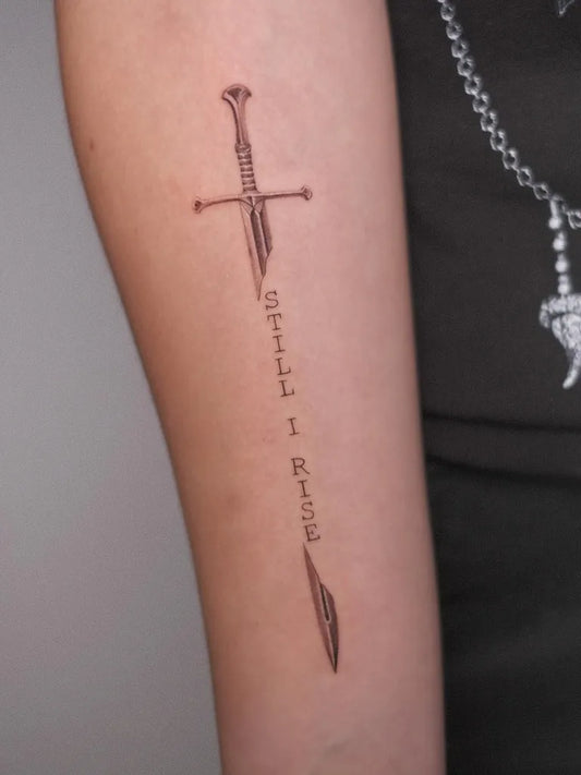 Medium Black and Grey Sword with Text on Women Arm Tattoo by @tattoo.moshkov