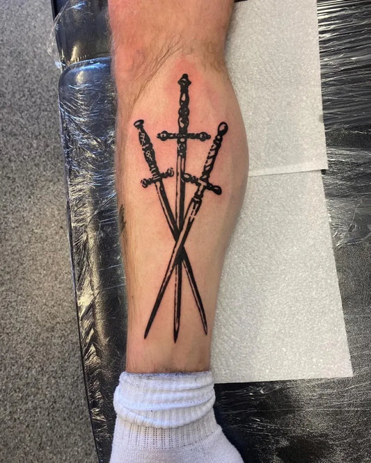 Medium Black and Grey Three Crossed Swords on Men Leg Tattoo by @immortal_tattoo