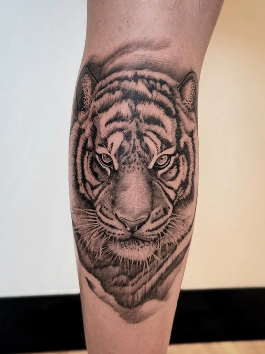 Medium Black and Grey Tiger Face on Women Leg Tattoo by @johnb.designs