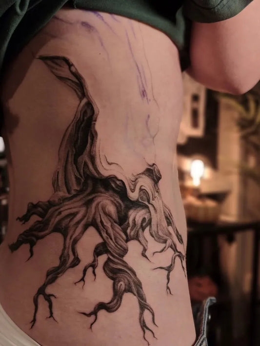 Medium Black and Grey Tree Tattoo on Women Rib by @matveeva_tattooart