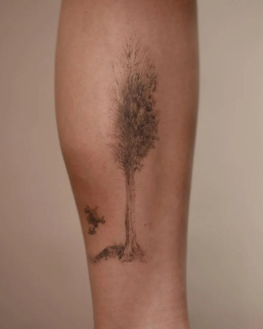 Medium Black and Grey Tree and Bird Tattoo on Women Leg by @anomori.art
