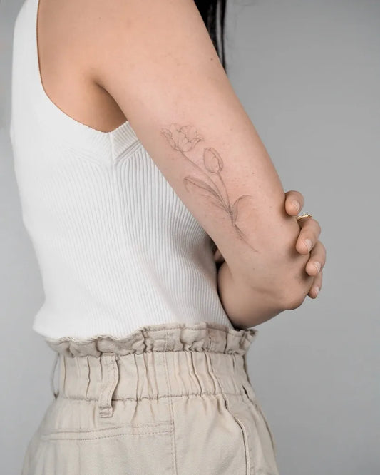 Medium Black and Grey Tulip Tattoo on Women Arm by @giada.tattooing